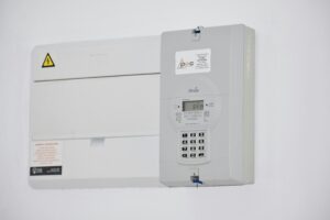 Electrical meter and fuse box on a white wall in Cape Town, South Africa, for energy monitoring or billing.