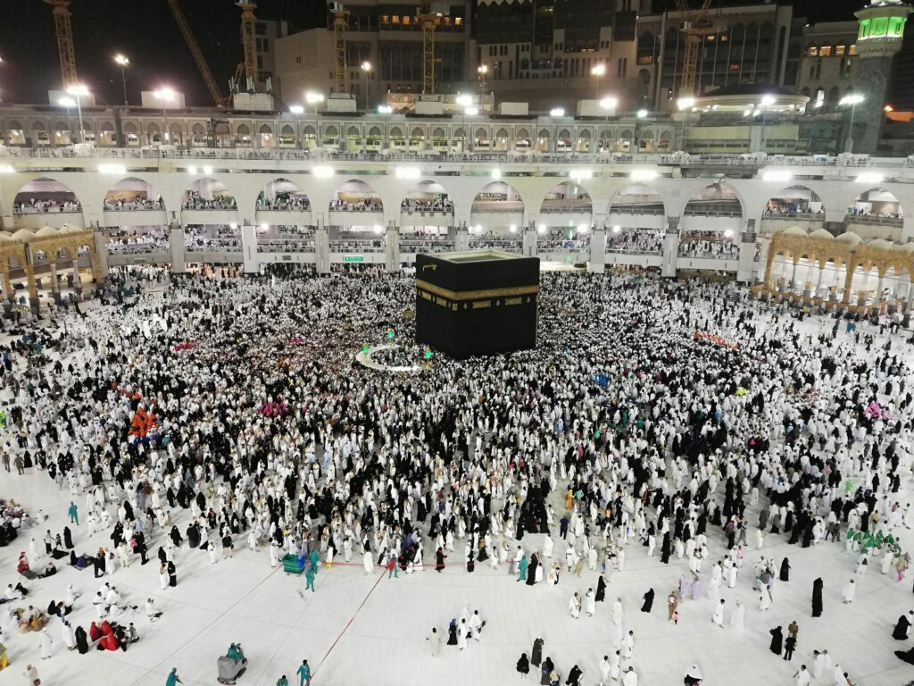 From above of crowded square around Kaaba cube in Great Mosque of Mecca at night time